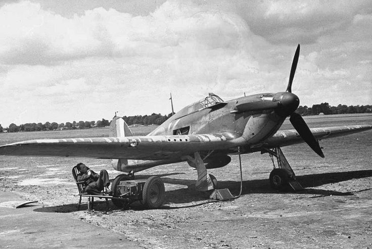 an old airplane sitting on top of a dirt field