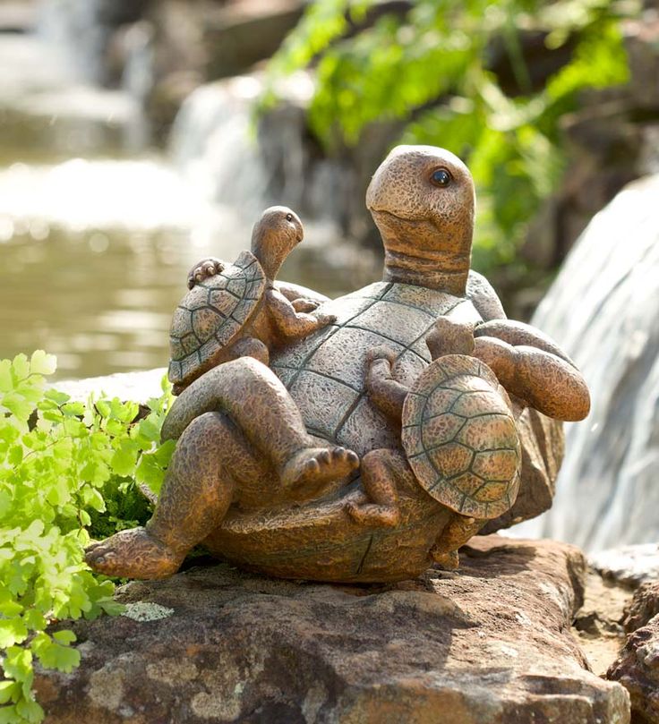 a statue of two turtles sitting on top of a rock