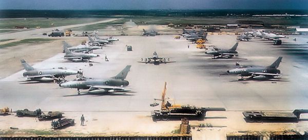 an airport filled with lots of airplanes parked on top of tarmac