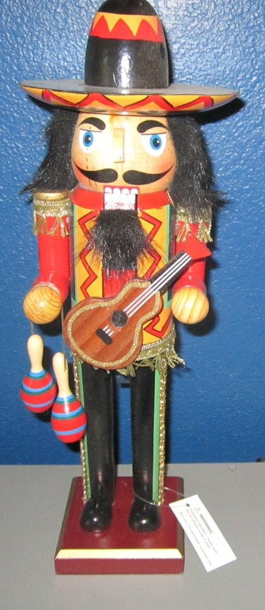 a wooden nutcracker with a guitar and hat