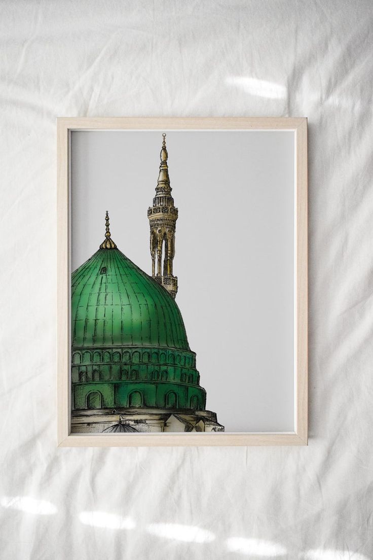 a framed photograph of a green dome on a white sheeted surface with shadows coming from the top