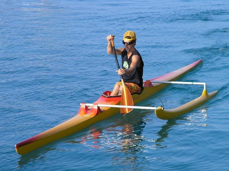 a man sitting on top of a kayak in the water