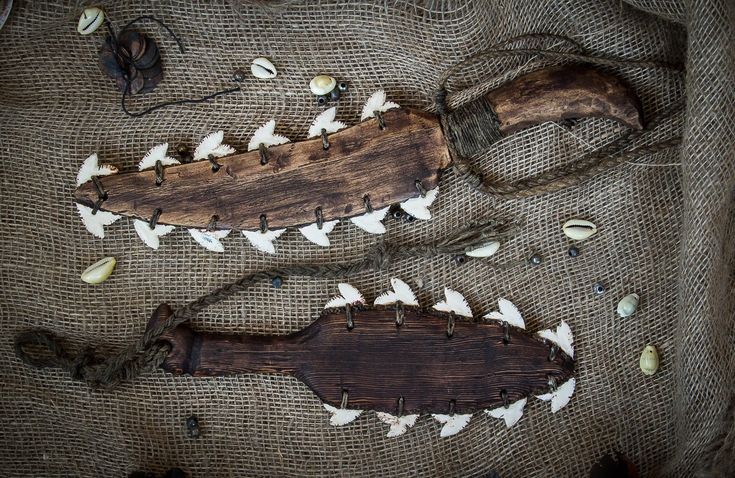 an old wooden object with white birds on it's side and some other items around it