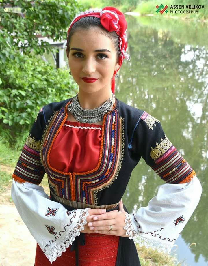 a woman in traditional dress posing for the camera