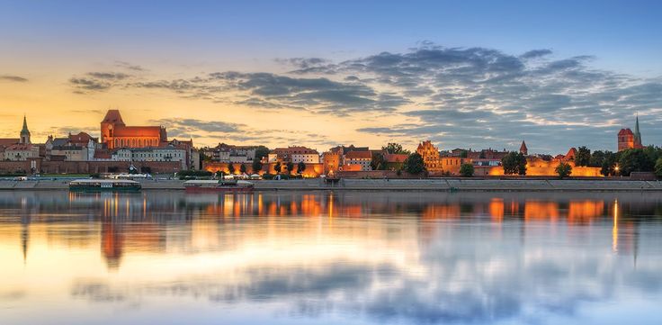 the city is reflected in the water at sunset