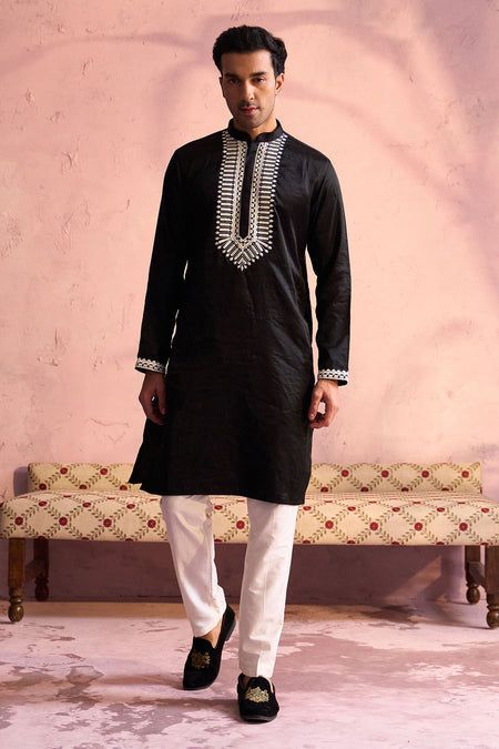 SHRESTHA BY VASTRAMAY Men's Black Silk Machine Embroidered Kurta Elegant and trendy, this black kurta features machine embroidery on the neckline. Made from a silk blend, it has a mandarin collar, long sleeves, and side slits for added comfort. Key Features Black silk blend with machine embroidery Mandarin collar Long sleeves Side slits Specifications Knee length Material & Care Top fabric: Silk blend Dry clean only Legal Disclaimer: The product is guaranteed to be 100% genuine. Product images a Casual Black Festive Kurta, Black Cotton Traditional Wear With Long Sleeves, Black Cotton Long Sleeve Traditional Wear, Black Long Sleeve Kurta For Festive Occasions, Black Long Sleeve Traditional Cotton Wear, Black Long Sleeve Festive Kurta, Black Cotton Traditional Wear For Festivals, Traditional Black Long Sleeve Kurta, Black Embroidered Cotton Traditional Wear