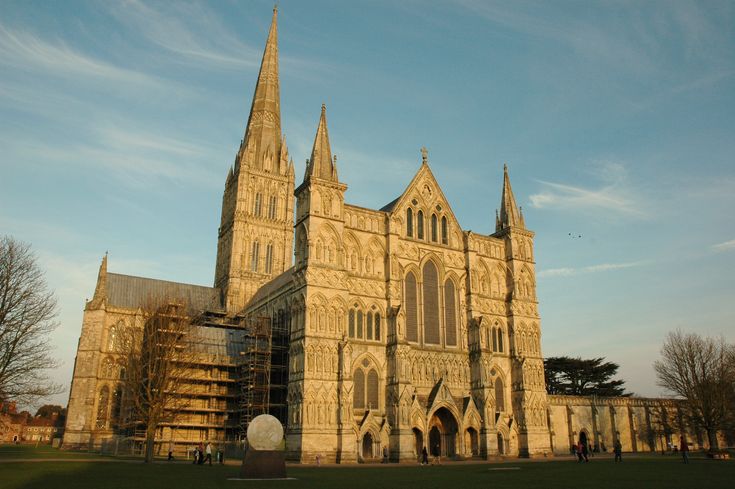 an old cathedral with scaffolding around it's windows and spires on a sunny day