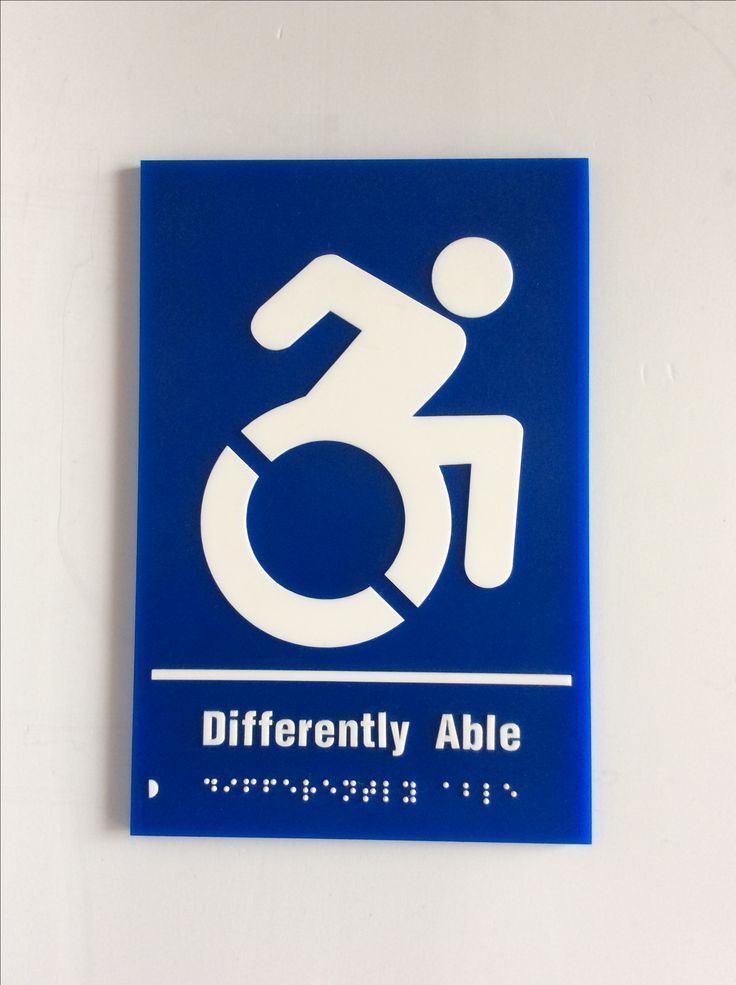 a blue and white sign with a man in a wheel chair on it's side