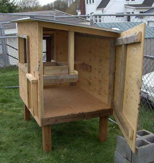 a chicken coop built into the side of a house