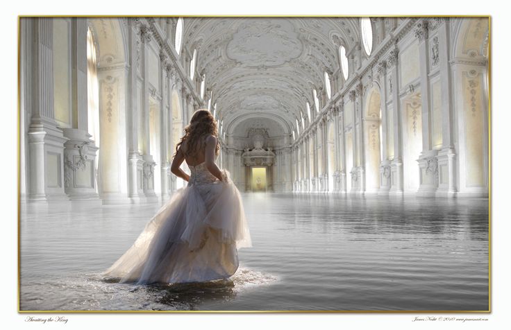 a woman in a white dress is standing in the middle of an empty hallway with columns