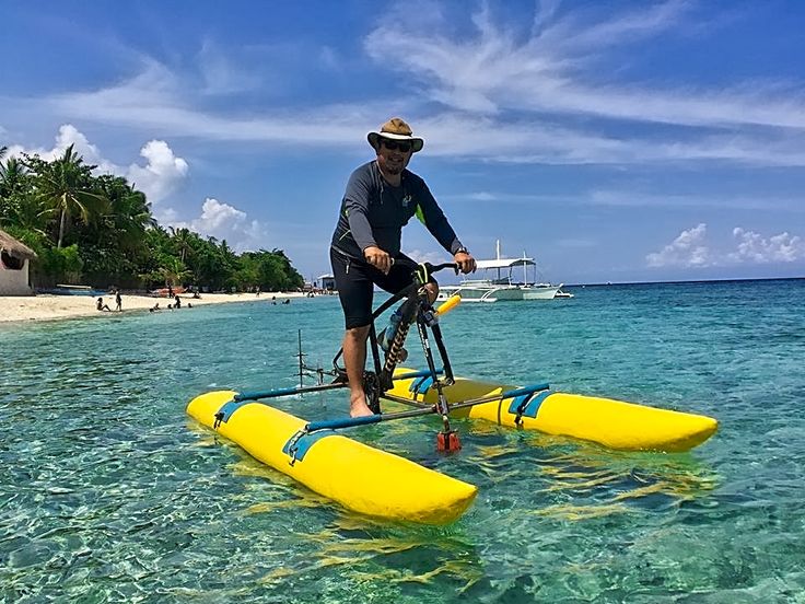 a man riding on top of a yellow surfboard in the ocean