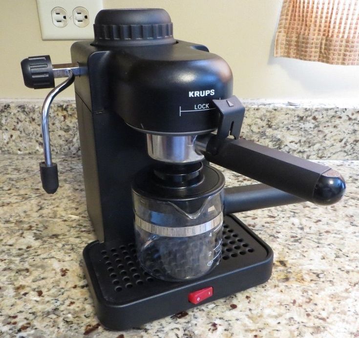 a black coffee maker sitting on top of a counter