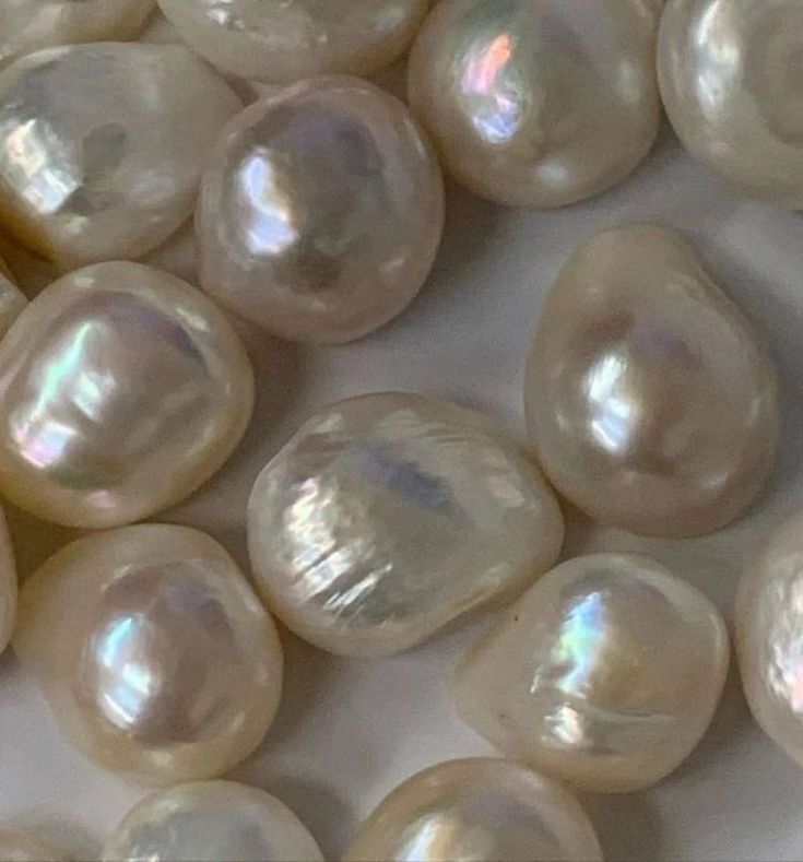 some white pearls are laying next to each other