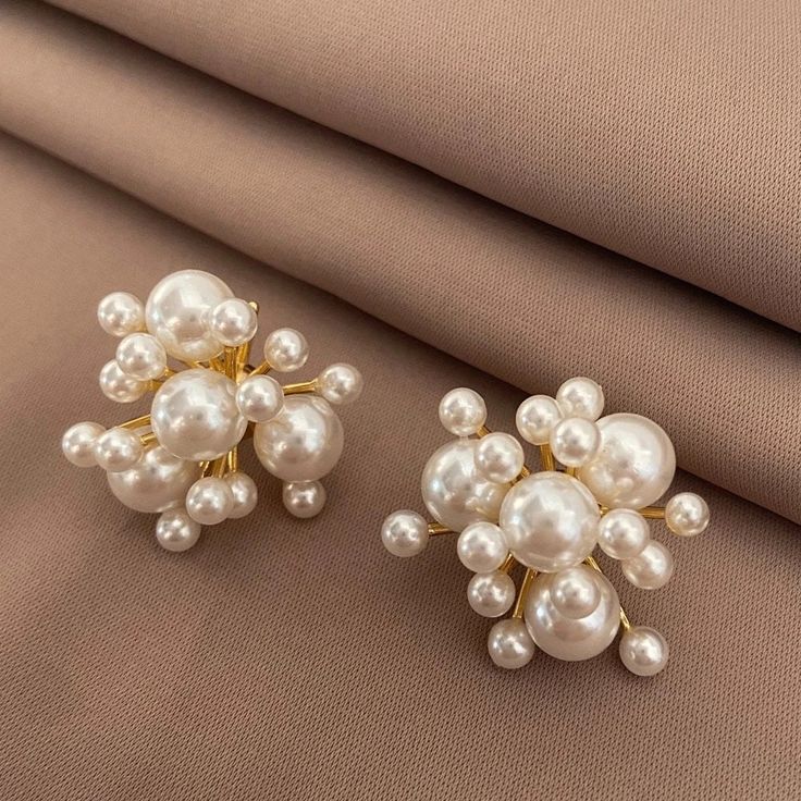 Introducing our stunning cluster pearl earrings, the ultimate accessory for an elegant party look. These exquisite earrings are made with freshwater pearls, showcasing their natural beauty. The firecracker design adds a touch of glamour and sophistication, making them a perfect addition to any outfit. With a convenient push back stud post, these earrings are not only stylish but also comfortable to wear. Elevate your style and make a statement with these pearl wedding earrings. Wedding Party Earrings, Party Pearl Earrings With Pearl Charm, Pearl White Pearl Earrings For Party, Party Bridal Earrings In Pearl White, Pearl Bridal Earrings For Party, Pearl White Bridal Earrings For Party, Pearl White Pearl Bridal Earrings For Party, Elegant Pearl Cluster Earrings For Party, Pearl White Bridal Earrings With Pearl Charm For Party