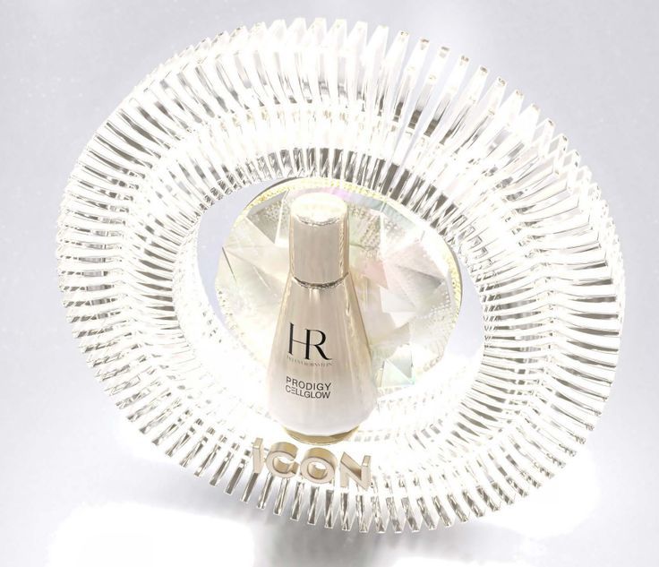 a clear glass plate with a white bottle on the top and silver trim around it