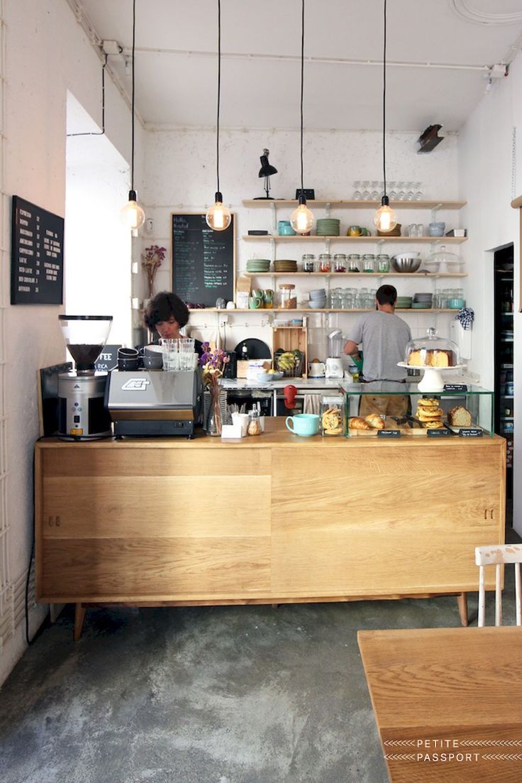 a person standing behind a counter in a coffee shop