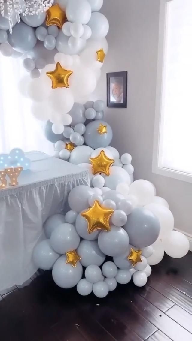 a table topped with balloons and stars