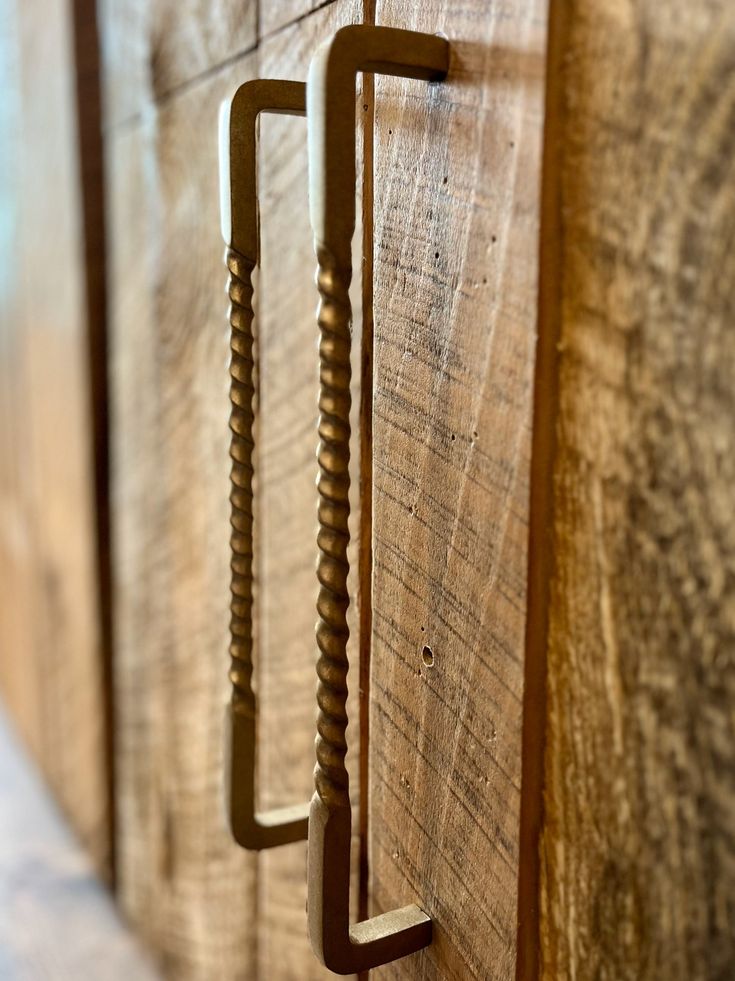 a close up of some wood with metal handles on the door handle and screws