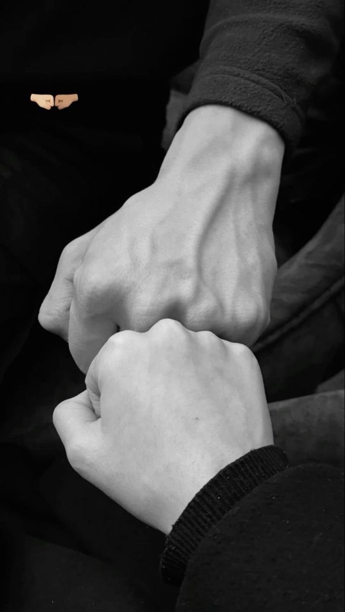 two hands holding each other with their fingers