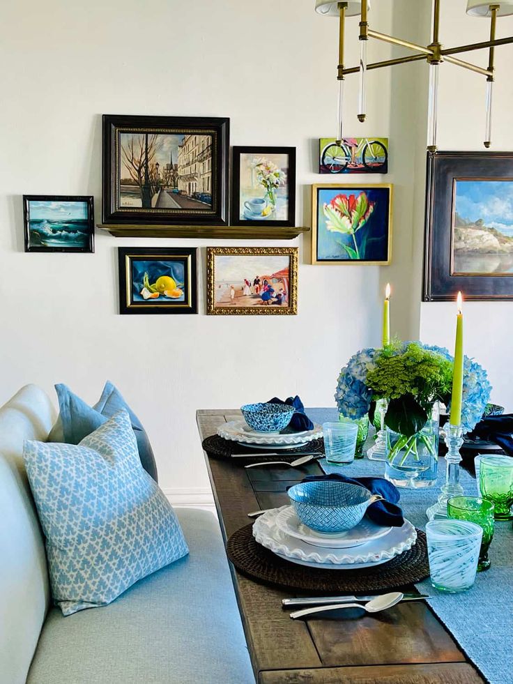 a dining room table is set with plates and place settings