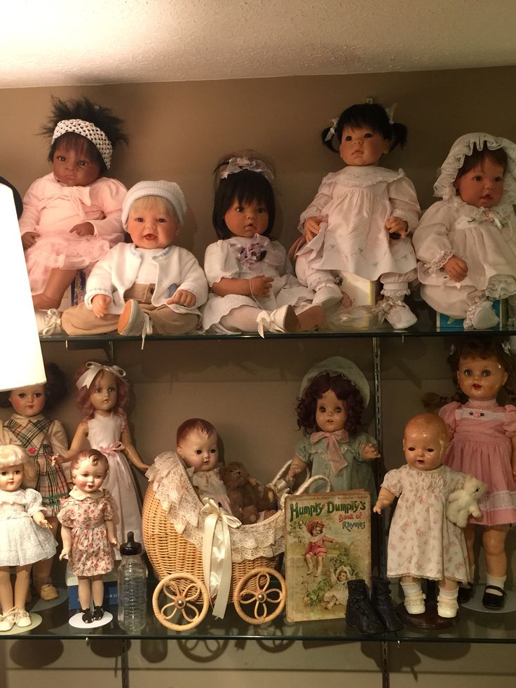 a shelf filled with lots of dolls on top of it