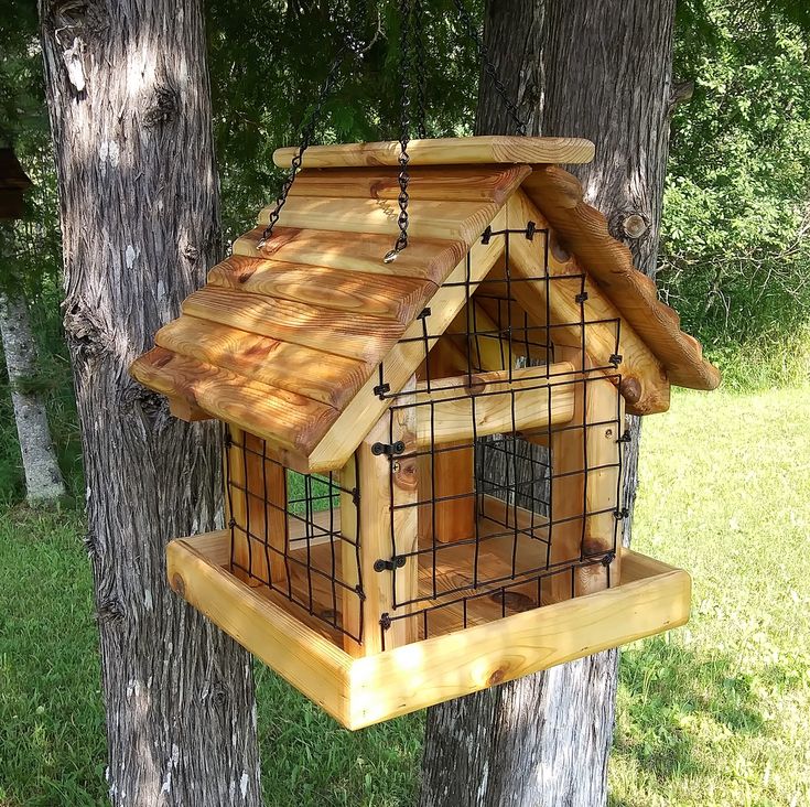 a wooden bird house hanging from a tree