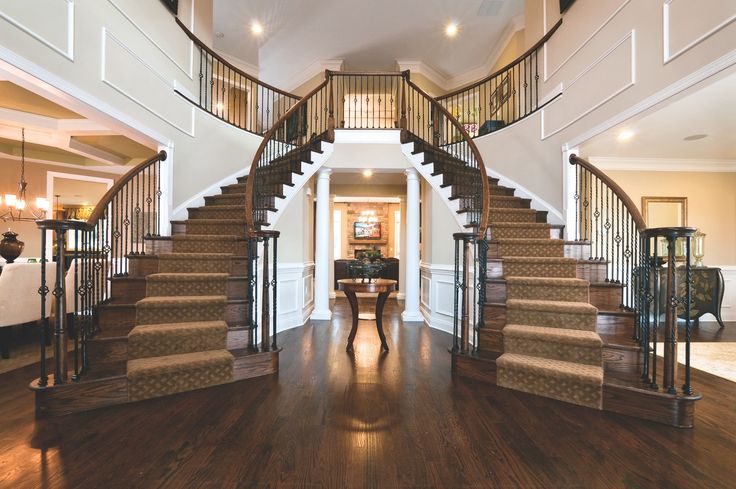 a large foyer with wooden floors and stairs