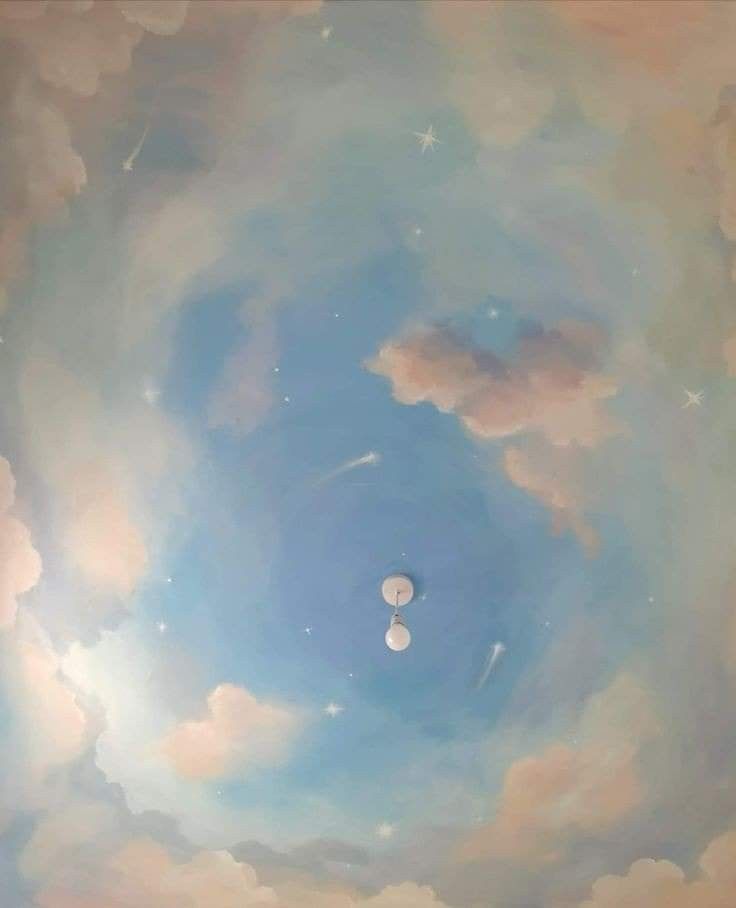 the sky is filled with clouds and there are two balloons floating in the air above it