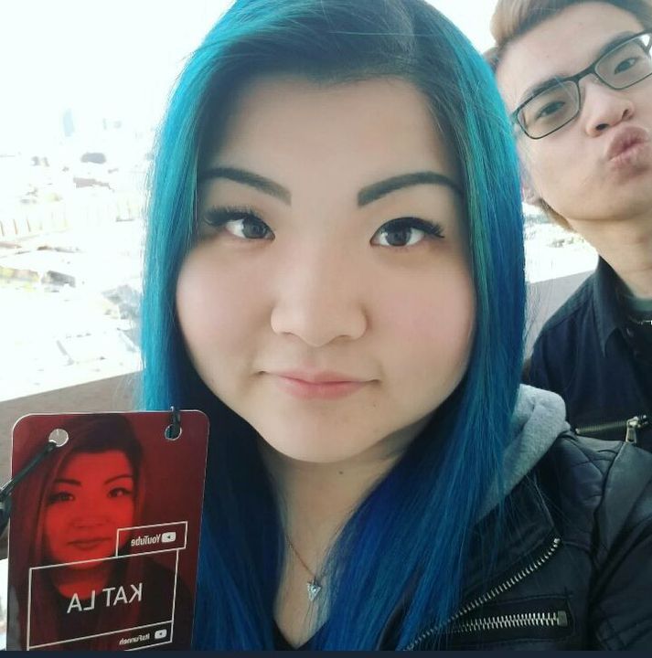 two people with blue hair are posing for the camera