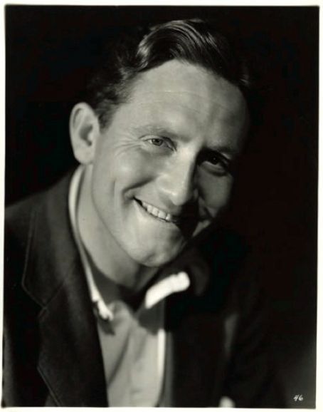 an old black and white photo of a smiling man