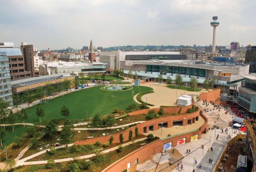 an aerial view of a city with lots of green space