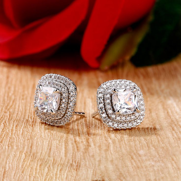 A smart choice you'll want to wear day after day, these sparkling stud earrings speak to your classic sense of style. Crafted in sterling silver, each spectacular earring features a shimmering cushion cut center stone wrapped in sparkling double halo frames, bringing out it's beauty and sparkle. Whether it's for a special gift or a treat for yourself,these elegant earrings are certain to be appreciated.Carat Weight: 1.35 ctStone Size: 6*6 mmStone Type: Jeulia® StoneNumber of Stones: 1 Stone Colo Square Cut Cubic Zirconia Earrings With Diamond Accents, Silver Square Cut Cubic Zirconia Earrings, Elegant Cushion Cut Cubic Zirconia Earrings, Elegant Halo Design Cushion Cut Earrings, Silver Cushion Cut Earrings With Diamond Accents, Elegant Cushion Cut Halo Earrings, Silver Cushion Cut Diamond Earrings With Accents, Square Cut Cubic Zirconia Earrings For Anniversary, Silver Diamond Earrings With Cushion Cut Accents