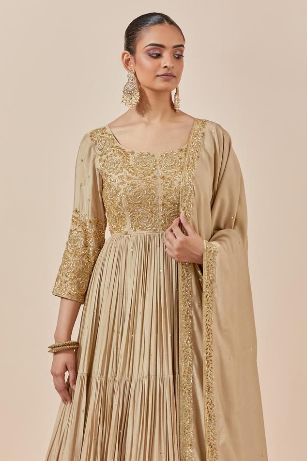 Beige chanderi silk full length anarkali with zardozi and sequin floral embroidery. Comes with embroidered border dupatta.
Components: 2
Pattern: Embroidered
Type Of Work: Floral Pattern
Neckline: Round
Sleeve Type: Straight Three Quarter
Fabric: Chanderi Silk
Color: Beige
Other Details: 
Attached lining
Back scoop neck
Tiered anarkali
Approx. product weight (in kgs): 2.5
Occasion: Wedding,Sangeet - Aza Fashions Gold Anarkali Floor-length Churidar, Gold Anarkali Churidar Floor-length, Gold Slub Silk Anarkali Set With Resham Embroidery, Gold Anarkali Set With Resham Embroidery In Slub Silk, Gold Anarkali Salwar Kameez, Transitional Raw Silk Anarkali Set For Reception, Art Silk Anarkali Set With Cutdana In Maxi Length, Elegant Slub Silk Anarkali Set For Reception, Raw Silk Anarkali Set For Reception And Festivals