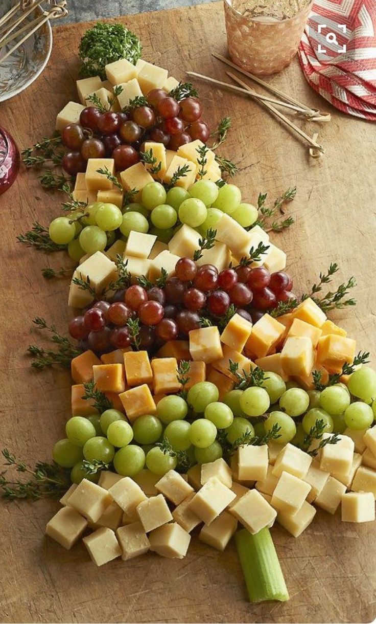 a christmas tree made out of cheese and grapes