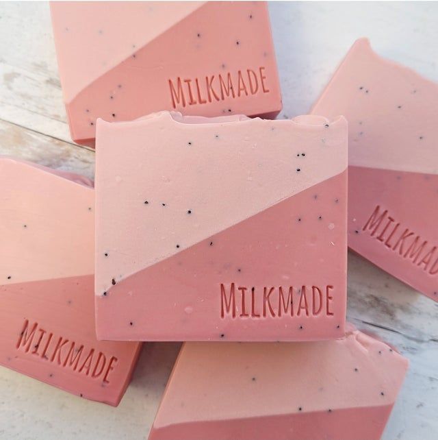 three pink soap bars with the words milk made, milkmade and milkmally written on them