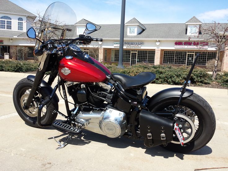 a red and black motorcycle parked in a parking lot