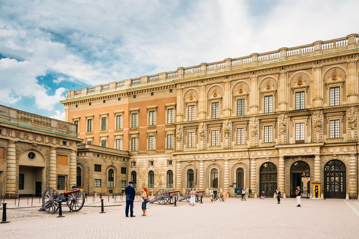 people are standing in front of an old building