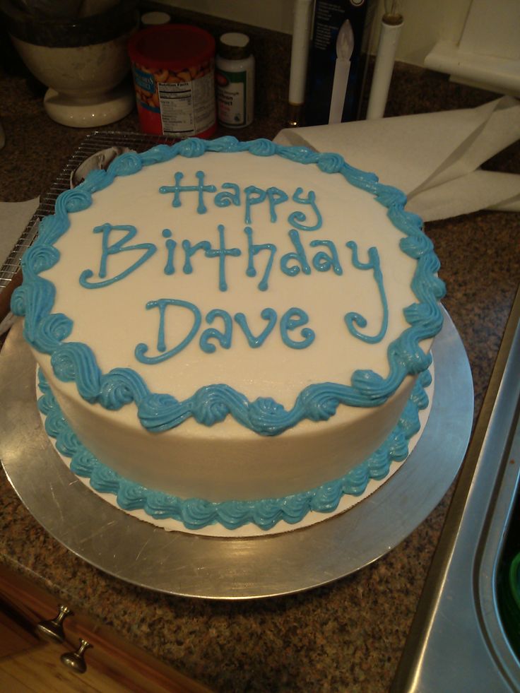 a birthday cake with blue frosting that says happy birthday dave on it sitting on a counter