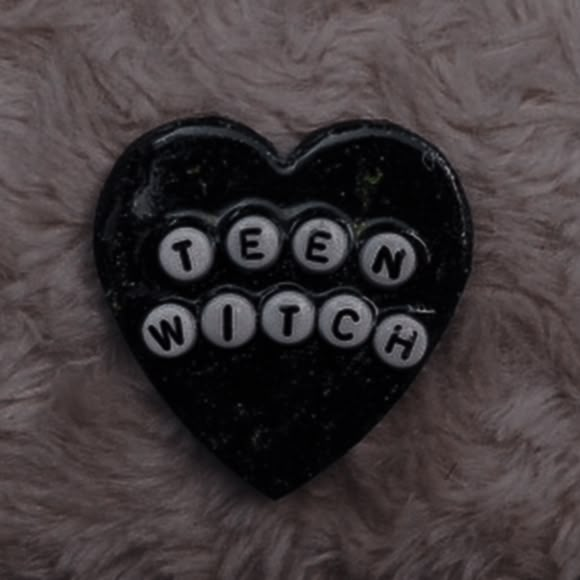 a black heart with the words teen witch written on it