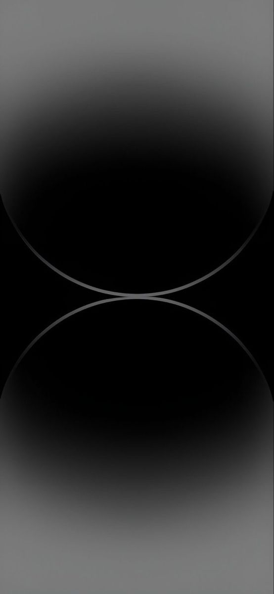 black and white photo of an oval shaped object in the middle of a dark background