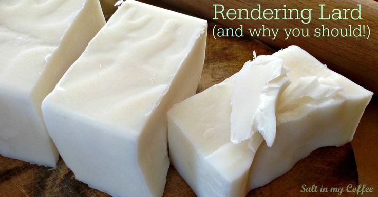 three pieces of white soap sitting on top of a wooden cutting board