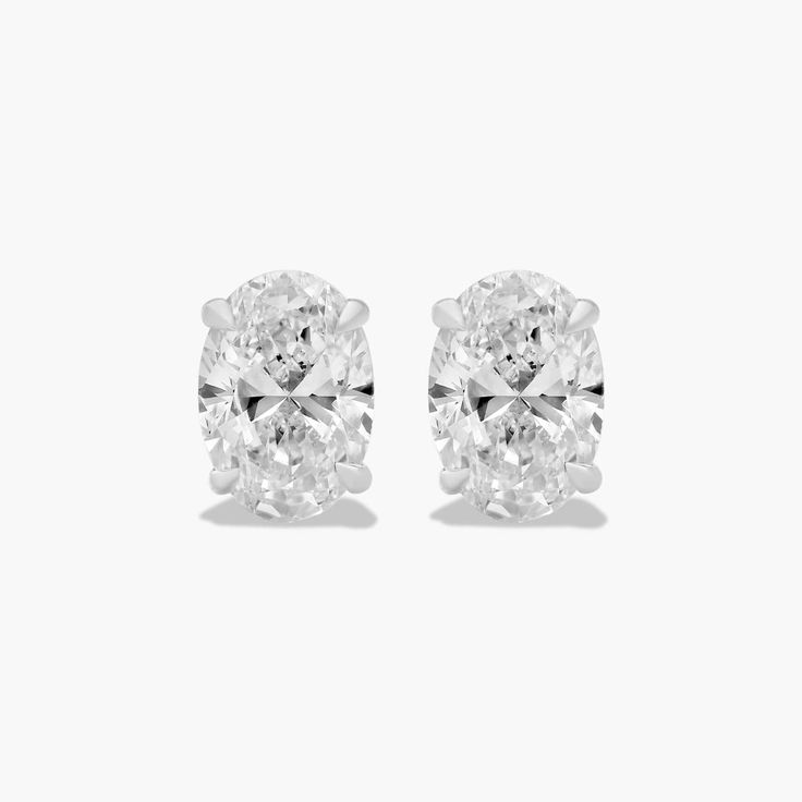 These classic oval-shaped diamond earrings are a timeless and elegant addition to any jewelry collection. The tapered basket setting showcases the unique beauty of the oval-shaped diamonds, which sparkle and shimmer with every move. The earrings are made of high-quality platinum, which is a durable and precious metal that will stand the test of time. Each earring features a single oval-shaped diamond that weighs approximately 1.00 carats in total. The diamonds are near-colorless (H-I color grade Gia Certified Oval White Gold Diamond Earrings, Princess Cut Diamond Earrings, Basket Setting, Shimmer And Shine, Shimmer N Shine, Earrings Diamond, Unique Characteristics, Oval Cut Diamond, Diamond Stud Earrings