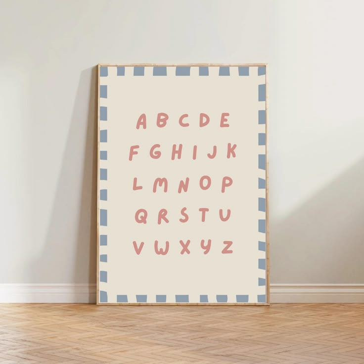 a poster with the alphabet on it in front of a wall