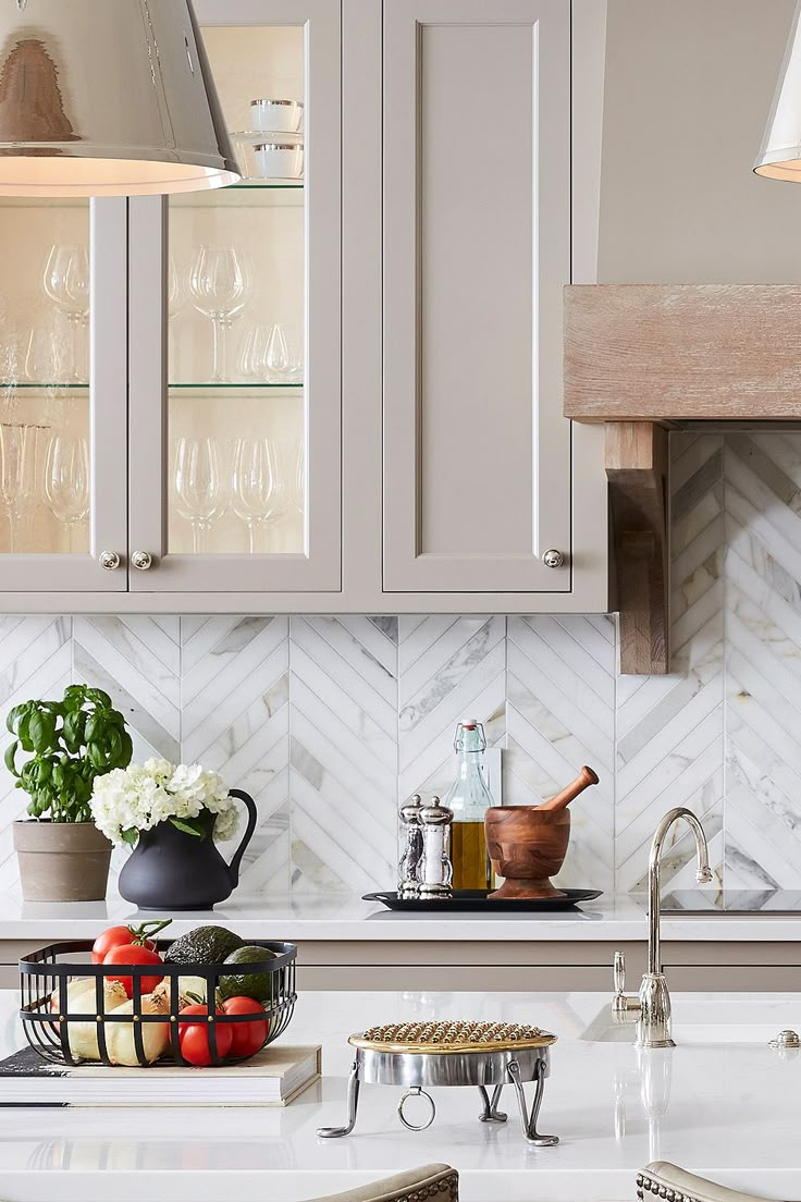 a kitchen with gray cabinets and white counter tops