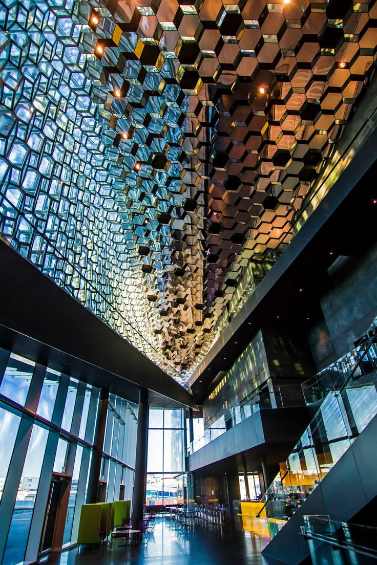 the inside of a building with many glass blocks hanging from it's ceiling and windows