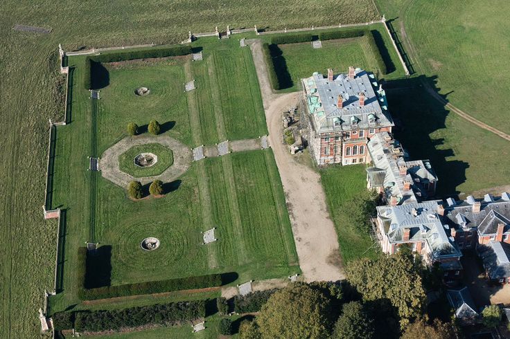 an aerial view of a large house in the middle of a field