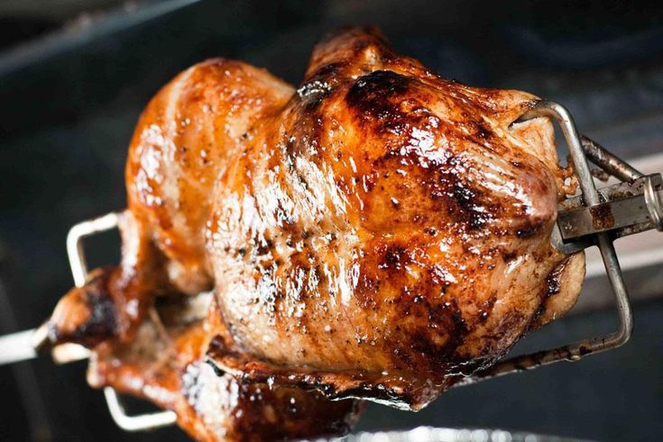 a close up of a cooked chicken on a grill