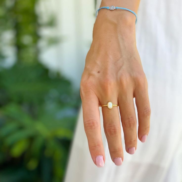 A dreamy and romantic opal ring featuring a round cut in a bezel setting and an elegant polished band in 14K gold plating over sterling silver.
A delicate vintage design and a glowing opal stone make this a truly unique piece. Timeless Adjustable Oval Rings, Stackable Oval 14k Gold Jewelry, Delicate Gold Gemstone Ring, Classic Stackable 14k Gold Jewelry, Delicate Gold Rings With Gemstones, Everyday 14k Gold Oval Jewelry, Everyday Opal Jewelry With Gemstones, Classic Everyday Jewelry With Round Shape, Everyday Oval Stackable Jewelry