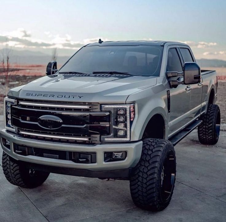 a silver truck parked on top of a parking lot