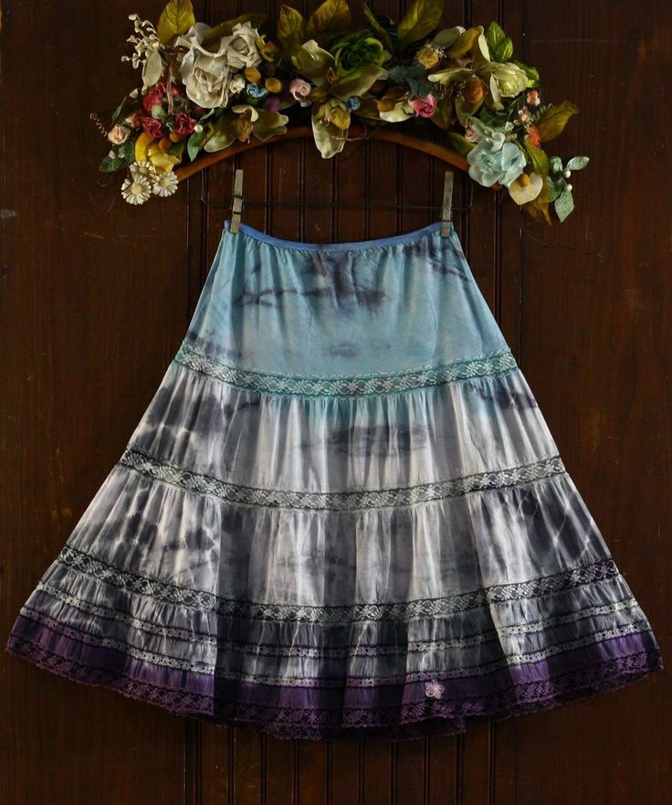 Gorgeous 1960's 6 tiered half slip skirt! The color is a light teal around the hips and fades to shades of gray in the middle with the tip of the skirt in a plum purple.  Full sweep (102 inch hem) A-frame skirt with 6 layers of lace.  This one is a really cute skirt. The fabric is a high quality silky soft satin Dacron polyester 45% / nylon 31% / cotton 34% blend Tag has been cut but is best for a size medium due to the looseness of the elastic band.  Opaque body, would make a cute skirt to wear out. The elastic in the waist is not in the best shape.  It does have some hold but not light the new stuff.   The elastic band is visibly damaged on the back right side (see pic). Pink 5 petal organza chiffon flower at the hem with a faux pearl in the center.  Shown on a size S/M dress form with a Chiffon Flower, Chiffon Flowers, Half Slip, 60s Dress, Cute Skirt, Slip Skirt, Light Teal, Shades Of Gray, Plum Purple